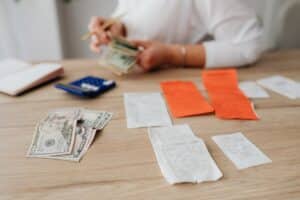 Person calculating house cleaning costs and budget for home services