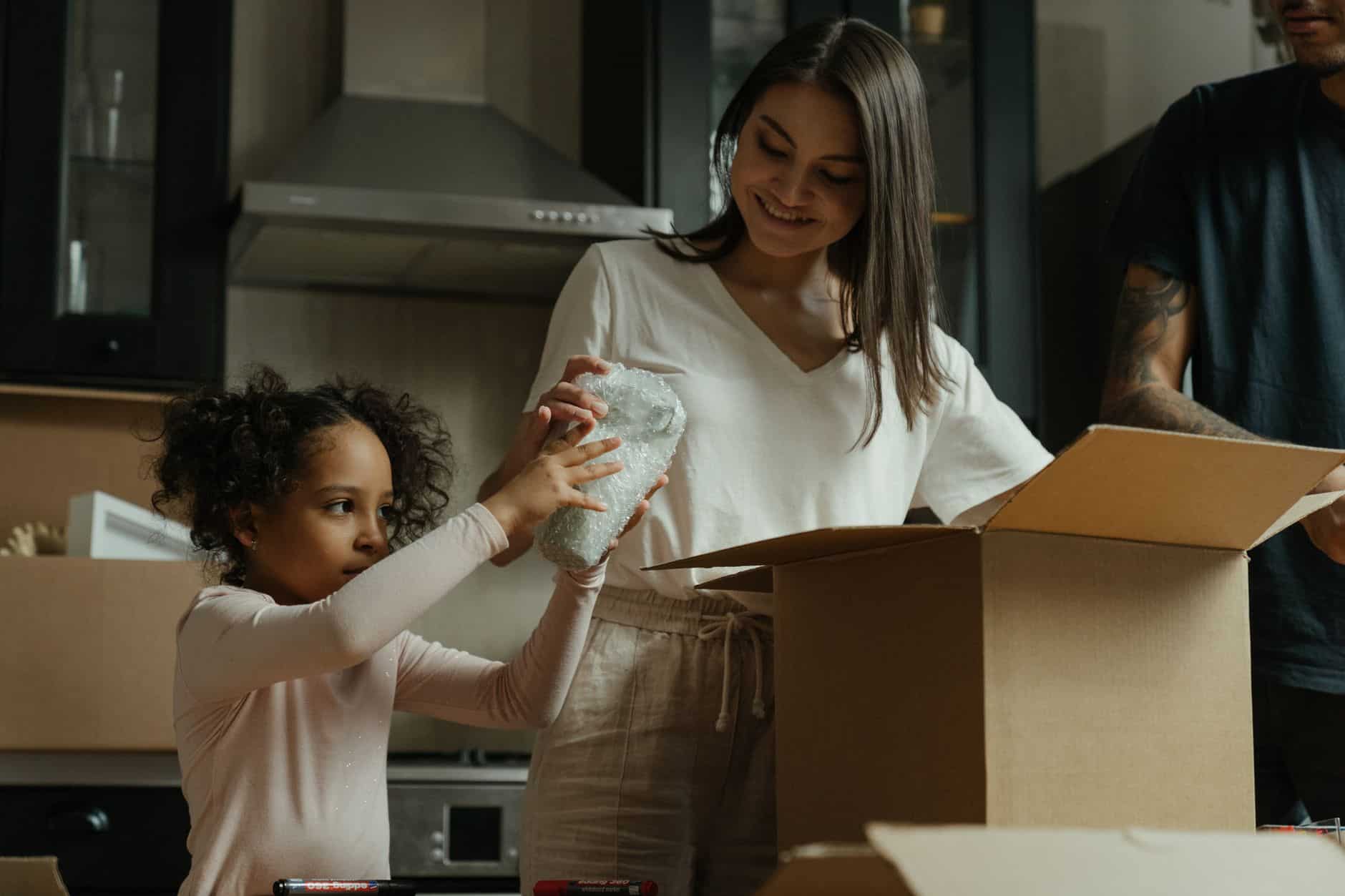Family unpacking boxes in their new home