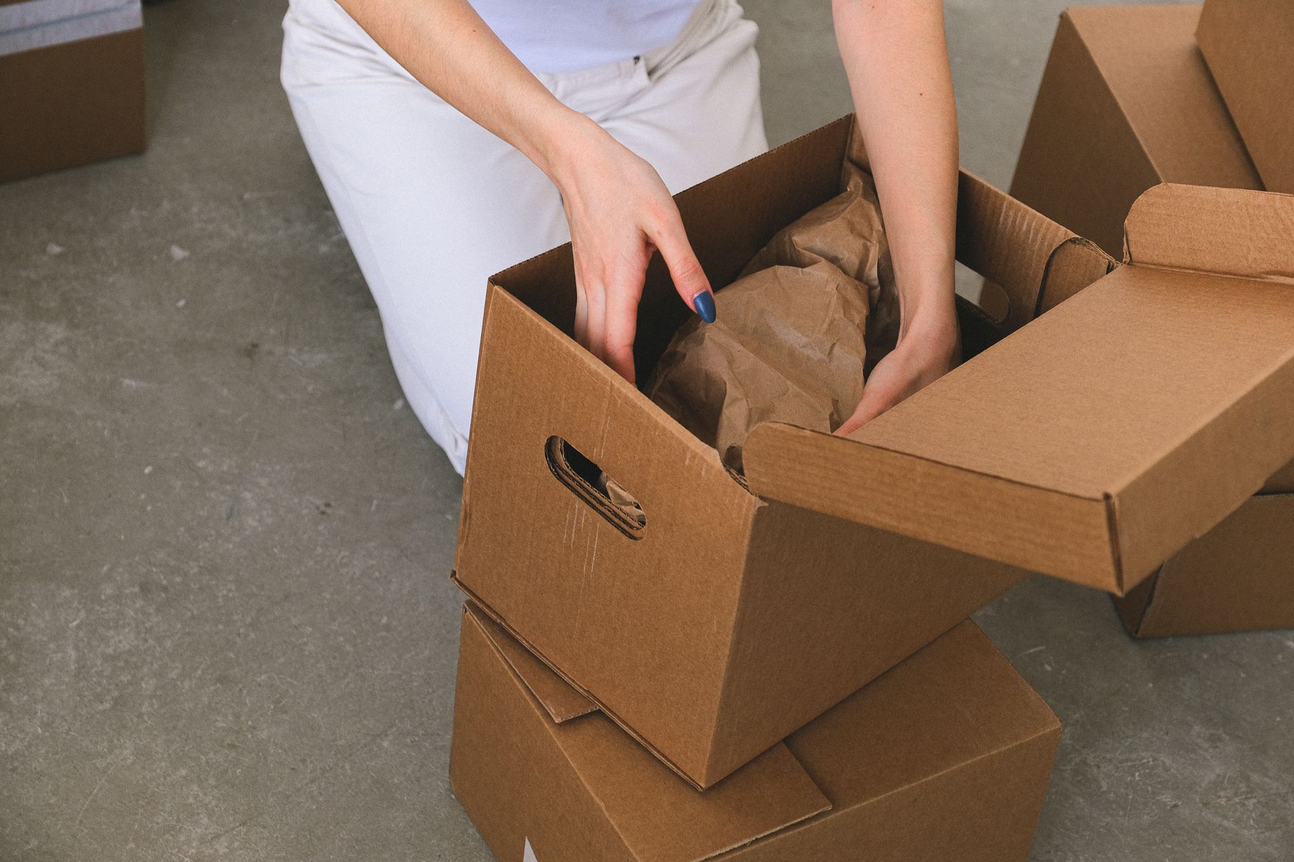 Family packing cardboard boxes for moving day